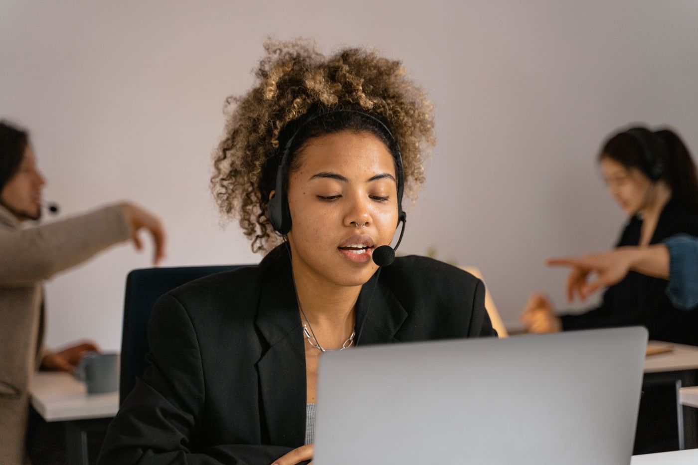 Debt collection agent wearing a headset and using a laptop