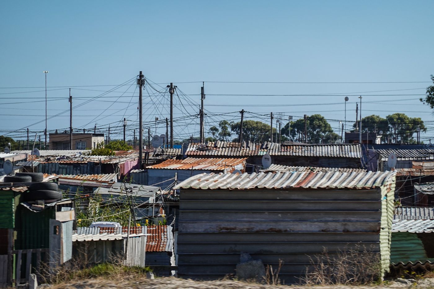 View across dense residential rooftops and utility power lines